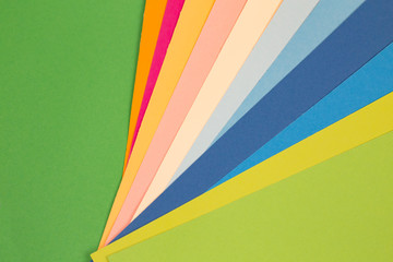 sheets of colored paper. Many colored sheets of paper are laid out in the harsh composition. background of colored paper.