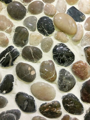Wall from different colour stones. Beautiful natural background.