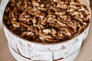 Cracked clean walnuts in rustic bowl. Close up