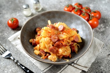 Stewed cabbage with potatoes and smoked sausages.