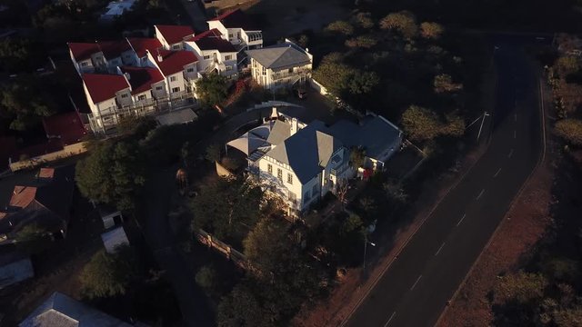 4K aerial Windhoek capital residential central hilly district bright sunset drone video with upmarket houses and old white walls German mansion on top of hill in Khomas Region, central Namibia
