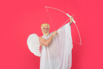 Valentines Day concept. Male angel with bow and arrow. Cupid angel with bow and arrows. Cupid in...