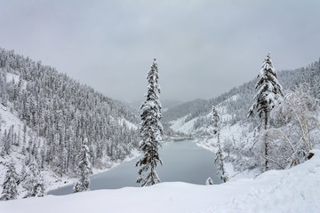 Fototapeta premium Amut Lake - Alpine landslide lake located in the Solnechny District of the Khabarovsk Kray, Russia . Beautiful taiga hills on Far East of Russia in early october. Taiga in winter. Beautiful nature