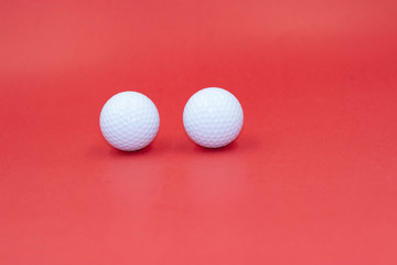 Golf balls are on red background