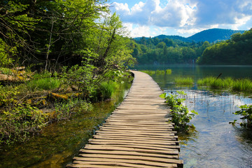 Wooden footbridge built above the blue waters of the Plitvice Lakes National Park in Croatia