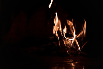 Orange-red flames in the fireplace at night