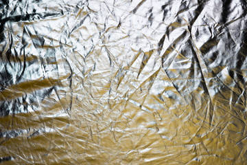 Silver and bronze foil reflector. Selective focus. Creative vintage background.