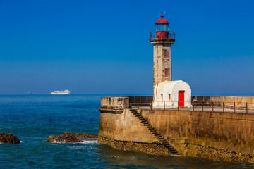 Fototapeta na wymiar Beautiful early spring day at the historical Felgueiras Lighthouse built on 1886 and located at Douro river mouth in Porto city