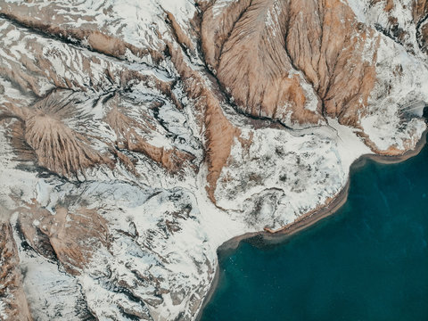 An aerial view over mountains valley at desert an amazing place for geologial. Top view aerial photo from flying drone of a beautiful arid rocky mountains. Amazing nature landscape perfect for travel