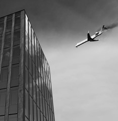 Airplane is flying above and has an engine fire