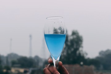 hand holding a glass of water