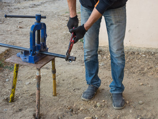 Man working with a gas pipe for central gas installation