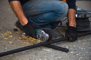 Man cutting a gas pipe for central gas installation