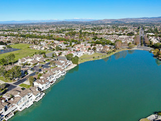 Obraz premium Aerial view of North Lake surrounded by residential neighborhood during blue sky day in Irvine, Orange County, USA