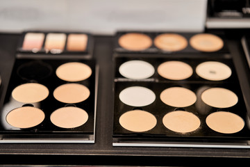 Blush and face powder. Professional cosmetics for make-up artists on a display rack