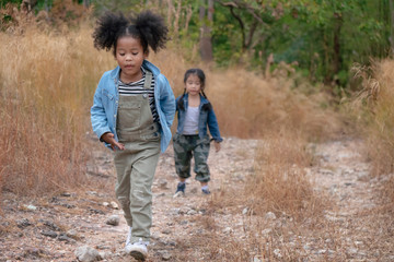 Naklejka na ściany i meble diverse people of african american children having fun walking together in forest