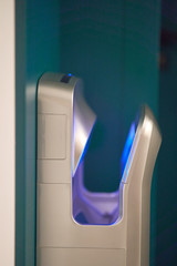 Automatic hand dryer. Stylish hand dryer with blue neon lights