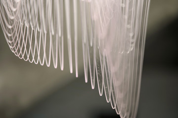 Design chandelier. Details of a chandelier close-up. White lamp indoors