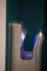 Automatic hand dryer. Stylish hand dryer with blue neon lights