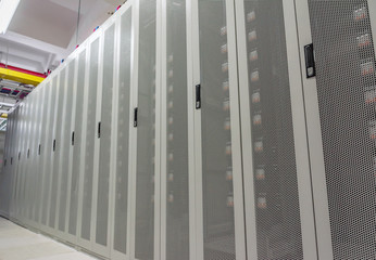 Data center neatly arranged white network cabinets