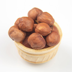 Different nuts in a waffle basket on a white background. Vitamin wholesome food.