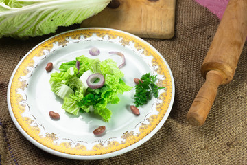Fresh napa cabbage salad served on table, top view,selective focus