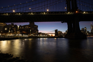 Manhattan and Brooklyn Bridges at dusk.