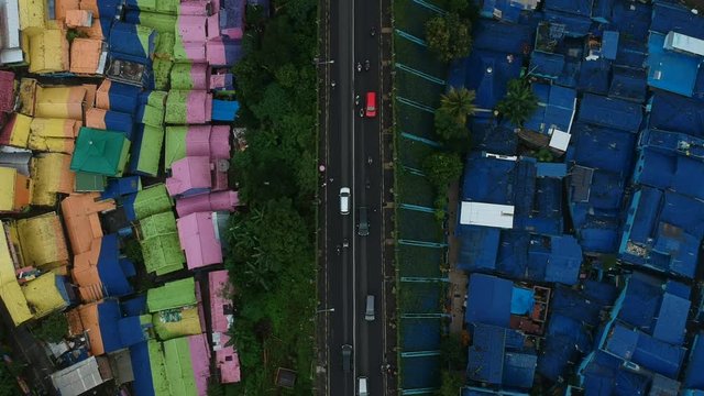 colored village Malang java indonesia splitted by highway birdeye shot