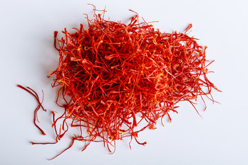 Naklejka premium Pile of red saffron threads isolated on a white background. Dear spice.