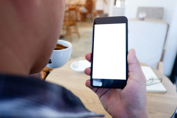 Mockup picture of business man's hands or woman’s hands holding smart phone with white blank screen in modern place.