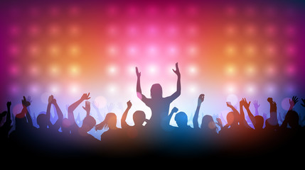 Fototapeta na wymiar Silhouette of people raise hand up dancing in concert with spotlight on stage background