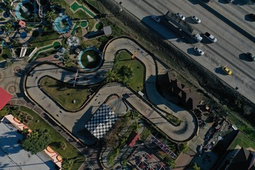 Aerial View Looking Down over go kart track with cars racing