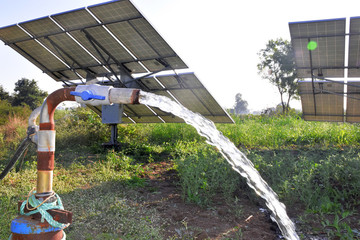 agricultural equipment for field irrigation, water jet, behind which is solar panel's,