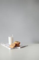 Stack of handmade oatmeal cookies with glass of milk