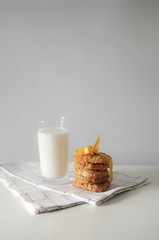Stack of handmade oatmeal cookies with glass of milk