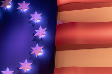 An early American flag showing thirteen stars in lights.
