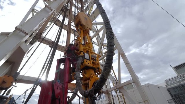 Oil rig operator assembles the top drive.