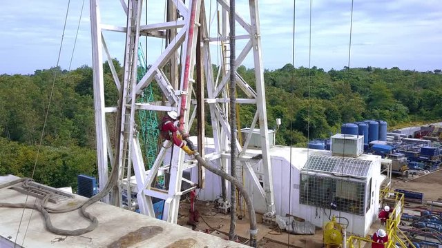 Oil rig operator assembles hose / standpipe for rig up procedure.