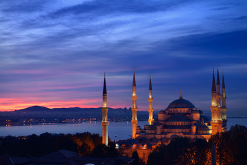 Lights on the Blue Mosque with red sky in the morning on the Bosphorus Sultanahmet Istanbul Turkey