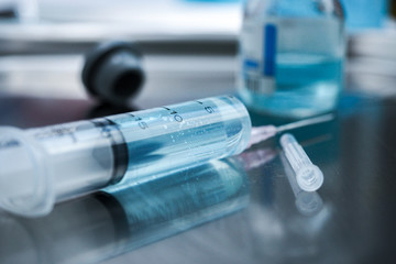 syringe and vials of medicine on white background