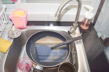washing dishes in sink