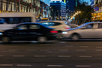 fast moving cars on street at night. blurred view of car traffic