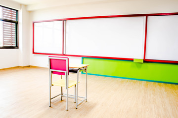 Desks, chairs and white board in the kindergarten classroom.