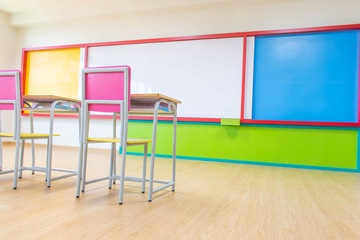 Desks, chairs and white board in the kindergarten classroom.