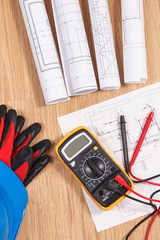 Electrical diagrams, protective helmet with gloves and multimeter for measurement in electrical...