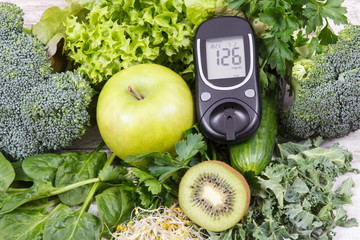 Glucose meter with fruits, vegetables and sprouts. Checking sugar level and healthy lifestyles