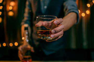 Barman pouring whiskey whiskey glass
