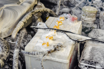 Wash the car engine by foam.