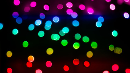 rainbow colored bokeh lights on dark background