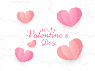 Calligraphy Happy Valentine's Day Text on White Cloud Background Decorated with Red and Pink Paper Cut Hearts.